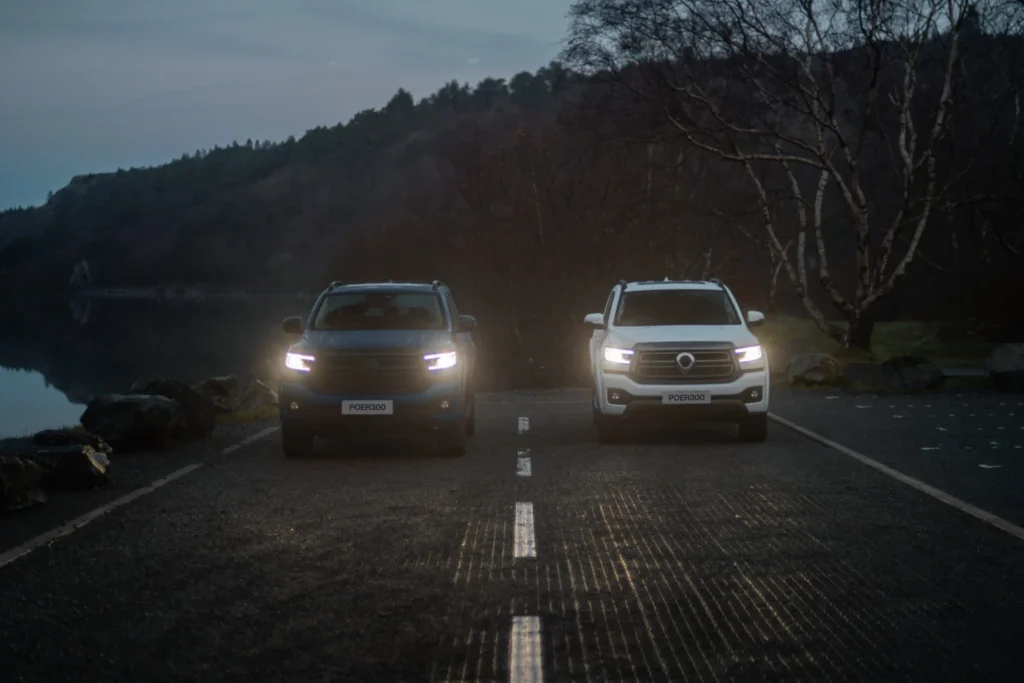 2 GWM POER 300s at dusk with headlights on. 