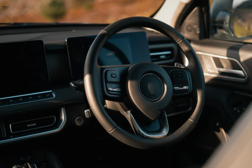 Steering wheel and interior of GWM POER 300.