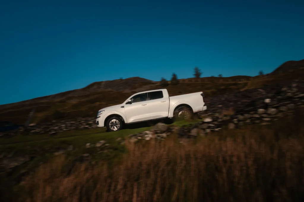 White GWM POER 300 going downhill. 