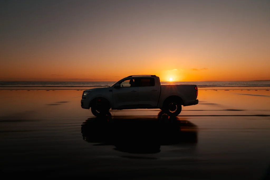 White GWM POER 300 on a beach at sunset.