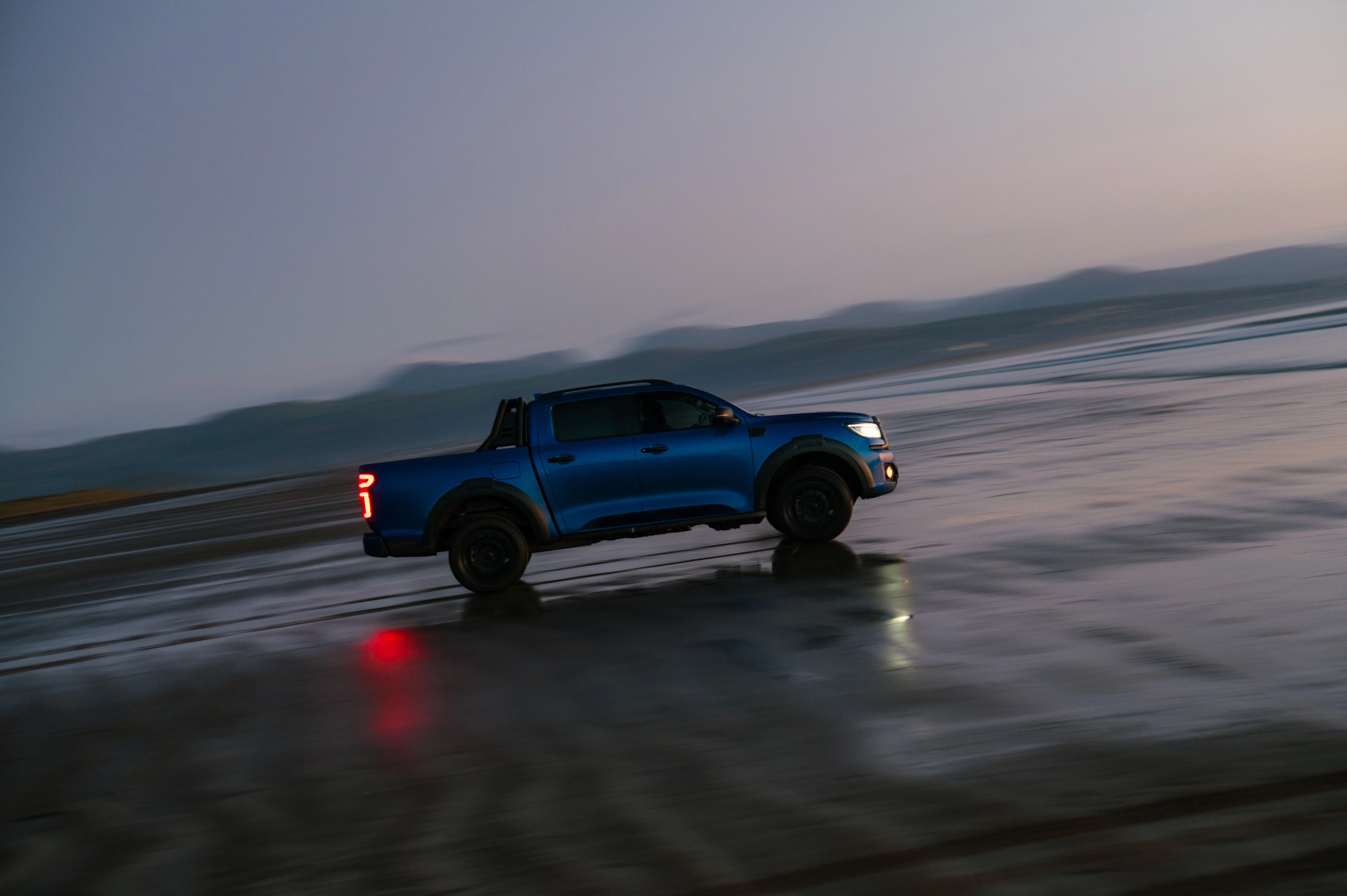 Blue GWM POER 300 driving on beach